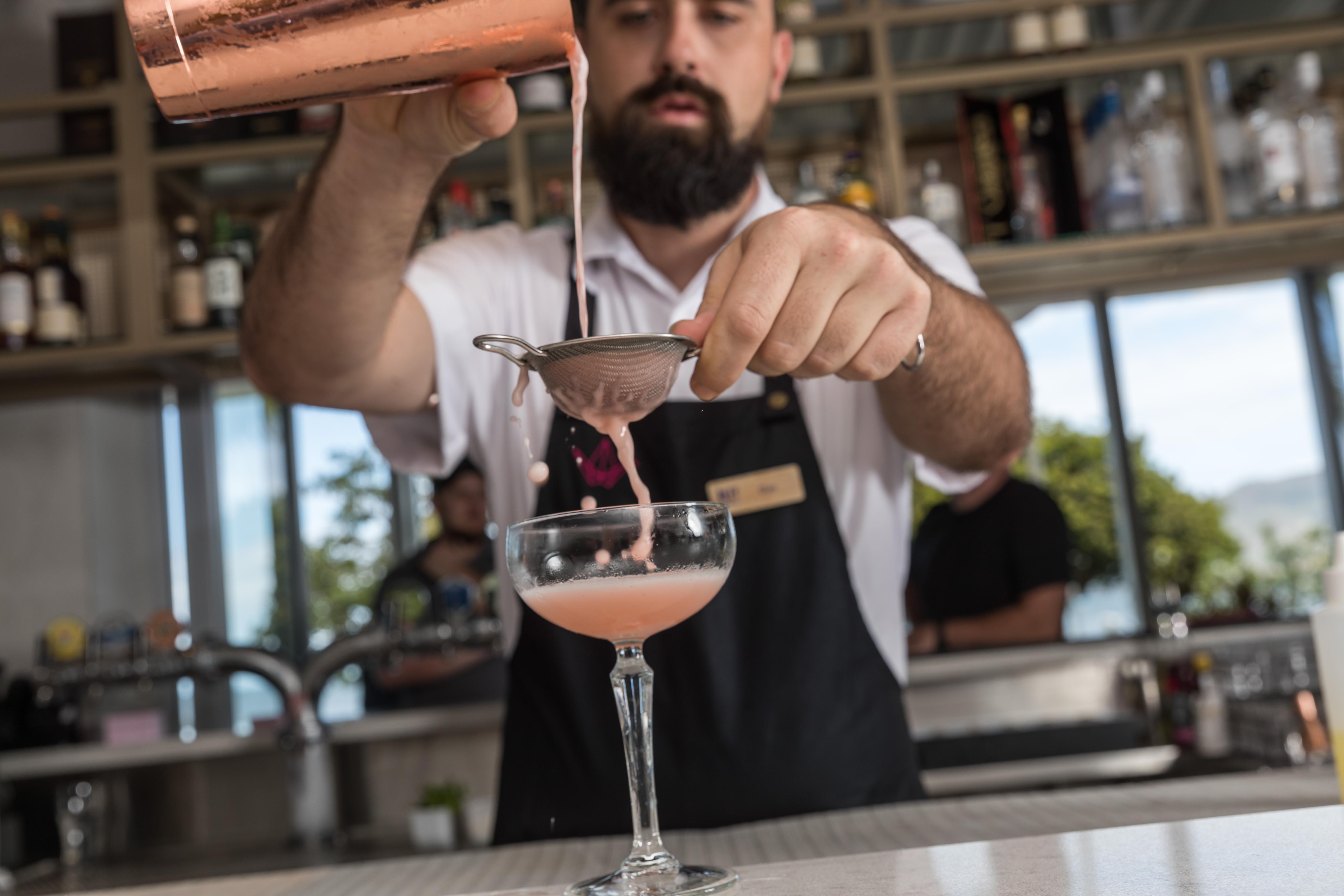 Crystalbrook Riley Hotel Cairns Exterior foto A bartender straining a cocktail